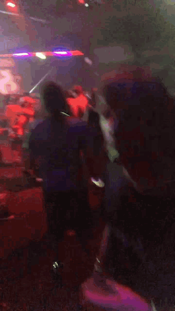 a blurry picture of a crowd of people in a night club