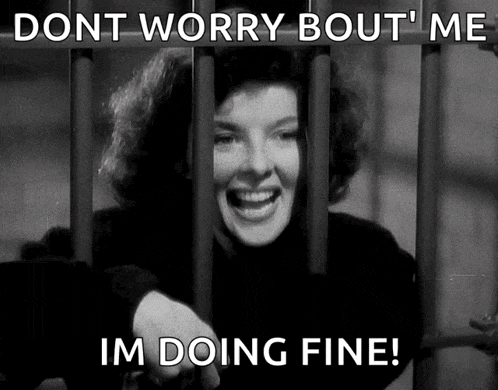 a black and white photo of a woman behind bars with the caption " dont worry bout me i 'm doing fine "
