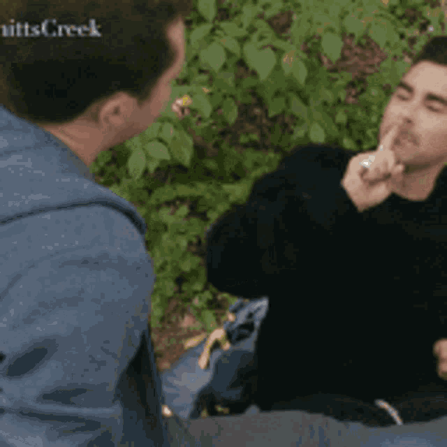 two men are having a conversation with the words mitts creek on the bottom right