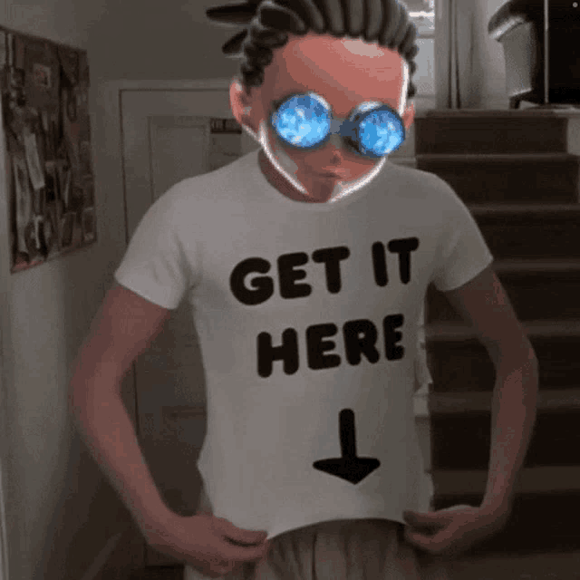 a man wearing a white shirt that says get it here