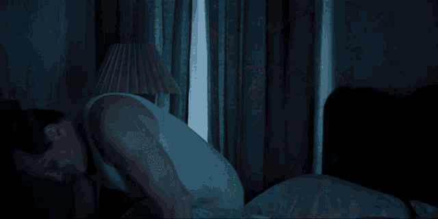 a man and a woman are laying in bed together