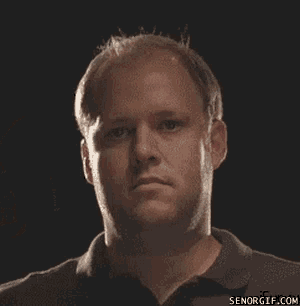 a man wearing boxing gloves is getting a punch in the face .