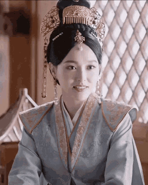 a woman in a costume with a comb on her head is smiling