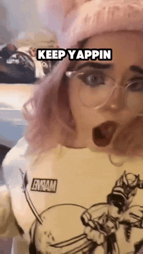 a girl with pink hair and glasses is wearing a shirt that says emma on it