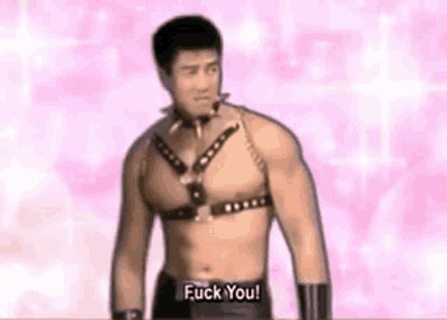 a shirtless man wearing a leather harness is standing in front of a pink background and says `` fuck you '' .