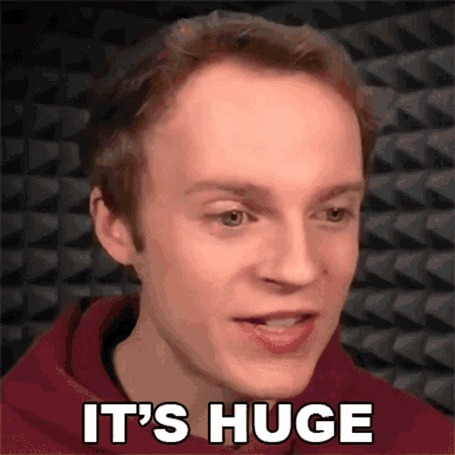 a man in a red hoodie with the words it 's huge on his face
