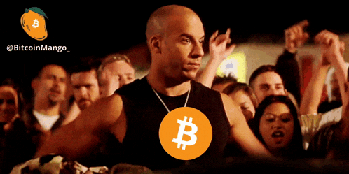a man wearing a black tank top with a large b on it stands in front of a crowd