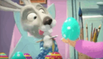 a cartoon rabbit is painting an easter egg