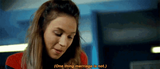 a woman in a red shirt is talking about marriage .