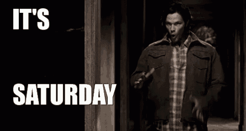 a man in a jacket is walking down a hallway with the words `` it 's saturday '' .