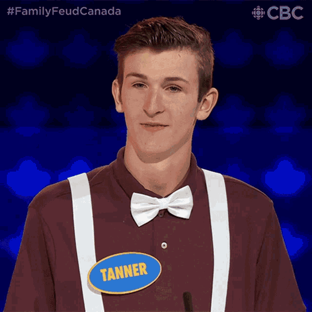 a young man wearing a bow tie and suspenders has a name tag that says tanner