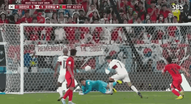 a soccer game is being played in front of a banner that says " remember love "