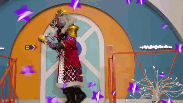 a person in a costume is standing in front of a sign that says e