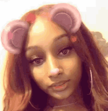 a close up of a woman 's face with a snapchat filter on her face .