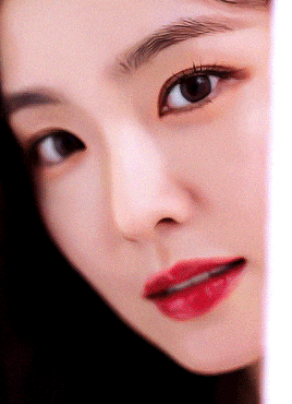 a close up of a woman 's face with red lips and black eyes