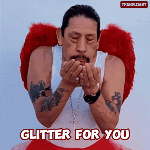 a man wearing angel wings blowing a kiss with the words glitter for you below him