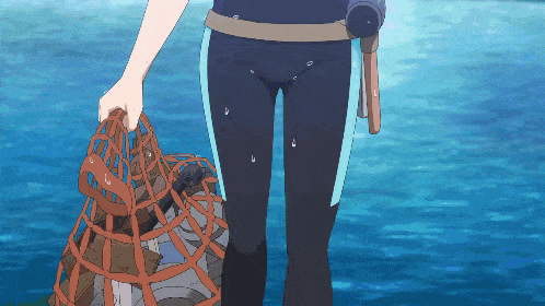 a person in a wet suit is holding a cage in their hand