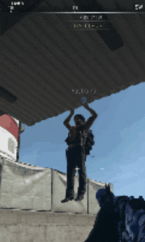 a man is hanging from a ceiling with the number x visible in the corner