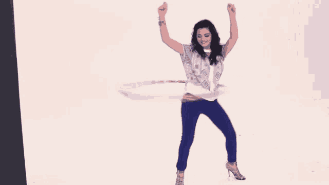 a woman is dancing with a hula hoop