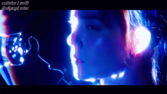 a close up of a person 's face with a blue light behind them and the words ' madjackson tumblr ' on the bottom