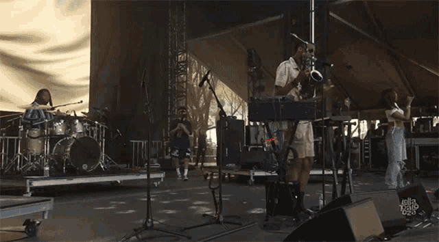 a man playing a keyboard on a stage with a sign that says delta sonic