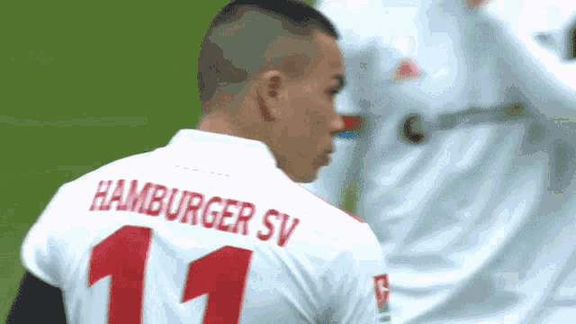a soccer player wearing a white jersey with the number 11 on the back