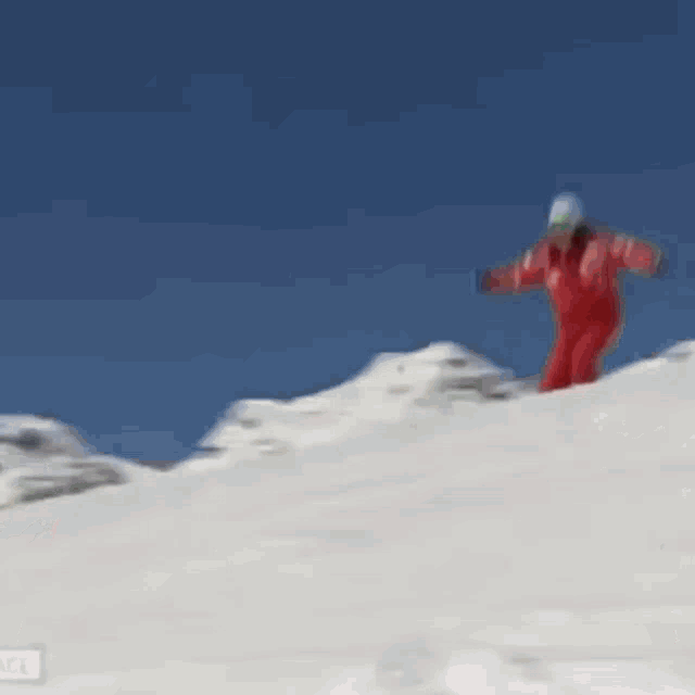 a person in a red jacket is jumping in the air with the words er ist die stimmungskanone nummer ein in serfas