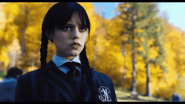 a girl in a school uniform with a logo for warner bros on her jacket