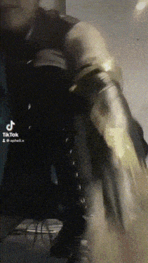 a man in a superhero costume is kneeling down and looking at the camera .