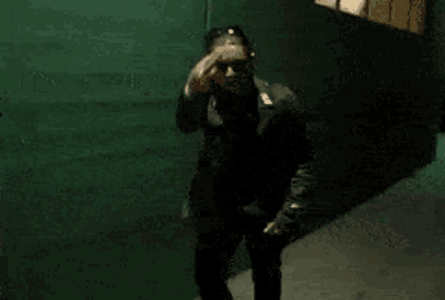 a person is standing on a sidewalk with a shadow on the ground