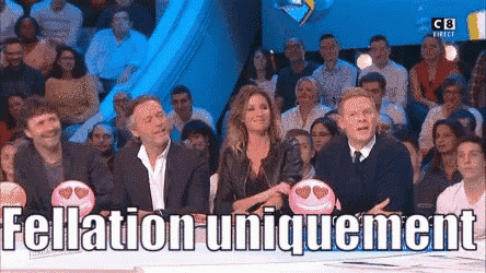 a group of people are sitting at a table with a sign that says fellation uniquement on it .