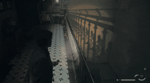 a man is standing in a dark hallway with a shadow on the wall