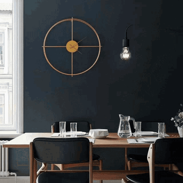 a large wall clock hangs above a dining room table