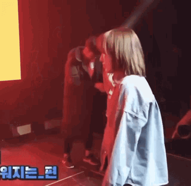 a man and a woman are standing next to each other on a stage in front of a crowd .