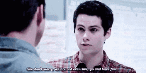 a man is talking to another man in a room .