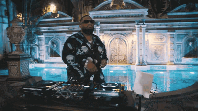 a man in a skull and crossbones shirt is playing music in front of a large building