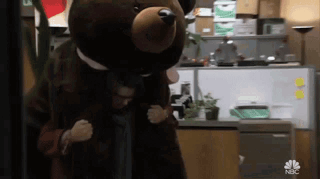a man in a teddy bear costume is carrying another man on his back