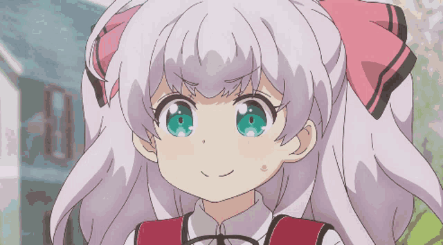 a girl with a pink bow on her hair is smiling