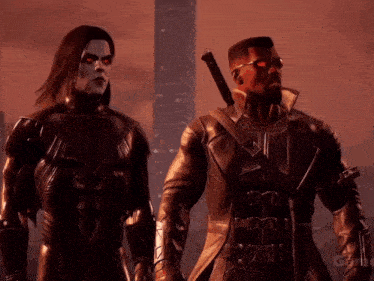 a man in a black suit stands next to another man in a black suit