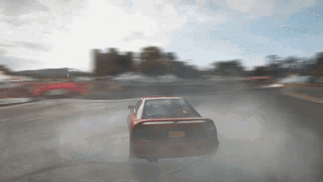 a red car with a new york license plate is driving down a road