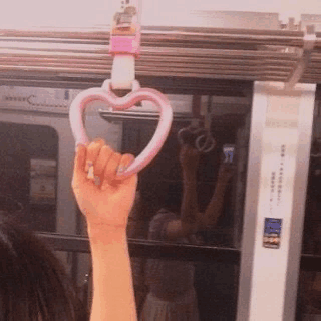 a person is holding a heart shaped handle on a train .