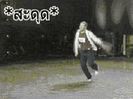 a person in a white jacket is jumping in the air while holding a tennis racket .