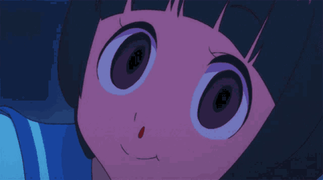 a close up of a girl 's face with big eyes and a blue shirt