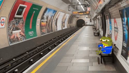 a frog sits on a bench in a subway station