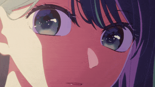a close up of a girl 's face with blue eyes and purple hair