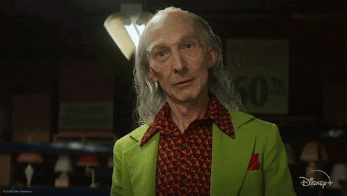 an older man in a green jacket says i do