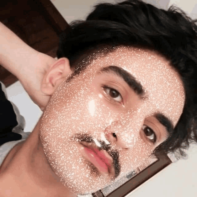 a man with a beard and a glittery face