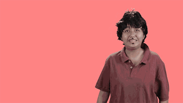 a man is clapping in front of a pink background with the words badhai ho