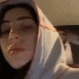 a close up of a person wearing a hoodie with their eyes closed .
