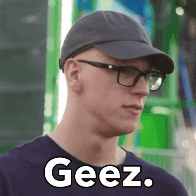 a man wearing glasses and a hat with the word geez written on it